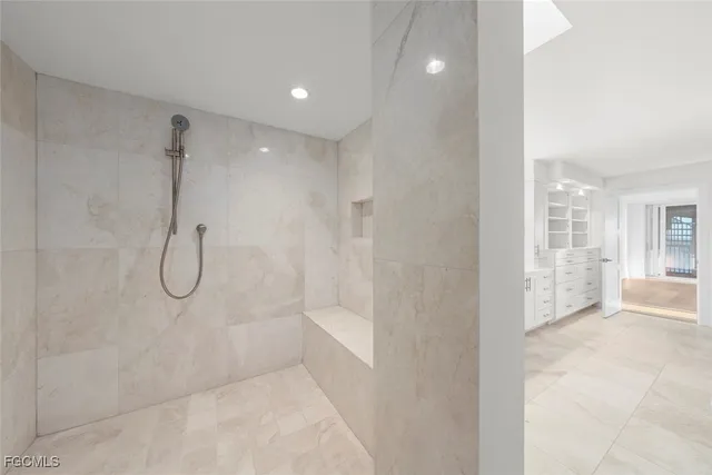 a bathroom with a glass shower door