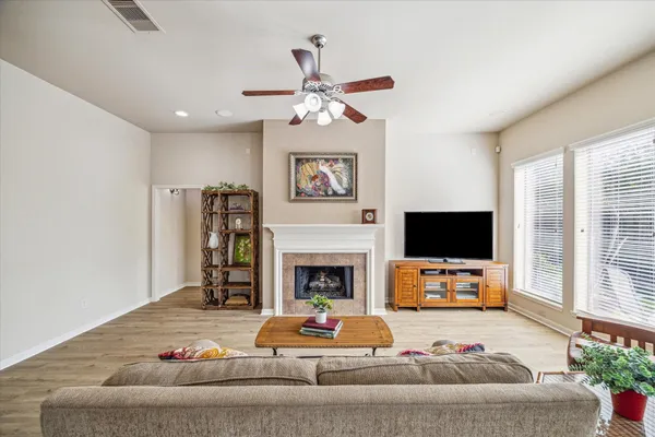 a living room with furniture a fireplace and a flat screen tv