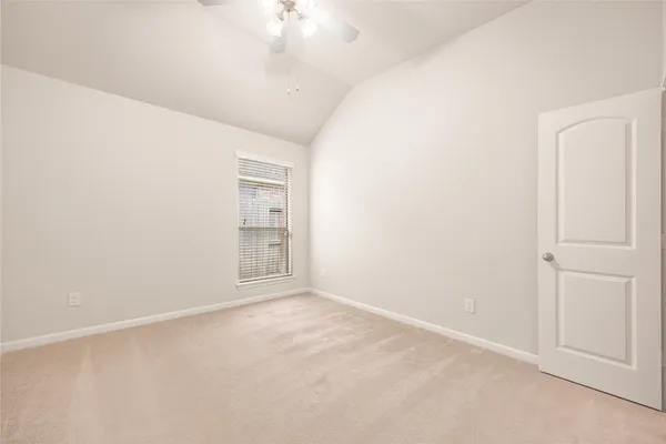an empty room with a chandelier fan