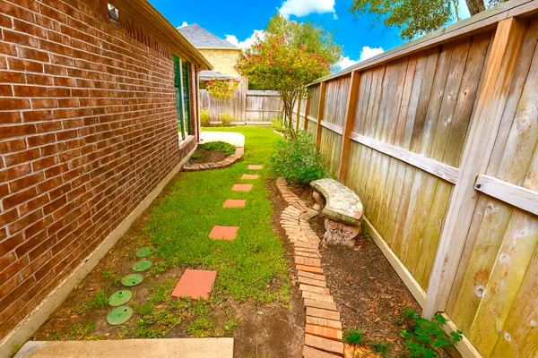 a view of a backyard with wooden fence