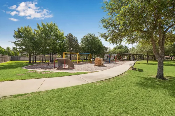 a view of a park with bench and trees