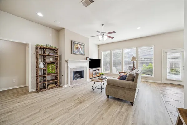 a living room with furniture large window and a fireplace