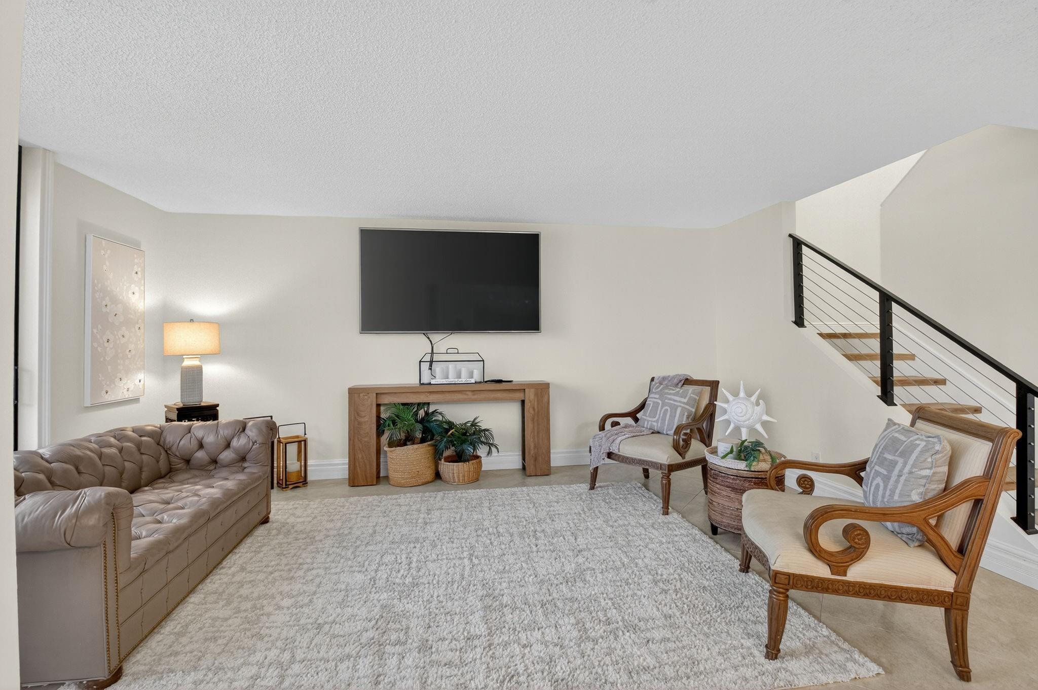 3802 Bridgewood Drive Boca Raton, FL 33434 - Photo 12 of 46 a living room with furniture a fireplace and a flat screen tv
