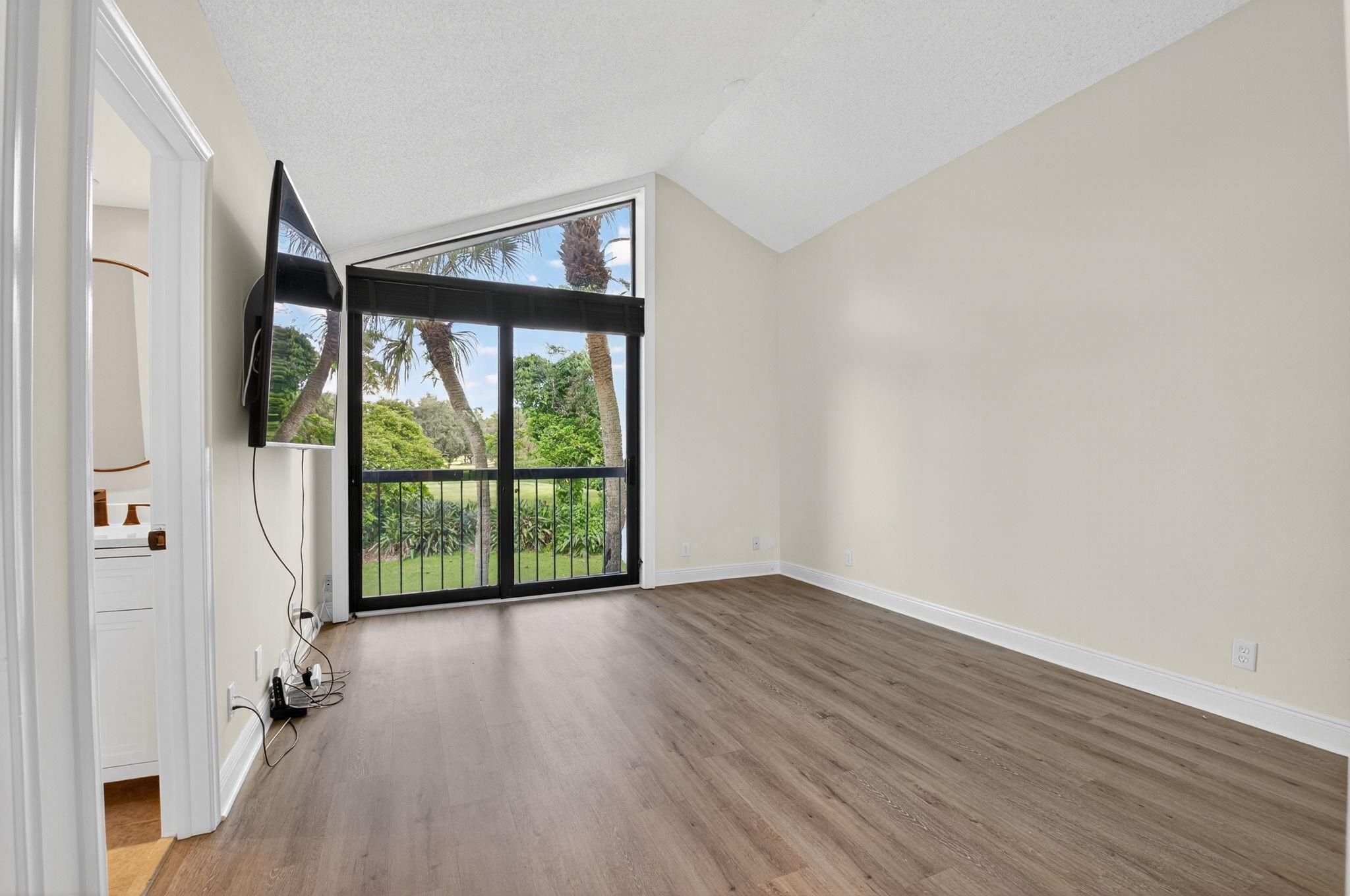 3802 Bridgewood Drive Boca Raton, FL 33434 - Photo 20 of 46 wooden floor in an empty room with a window