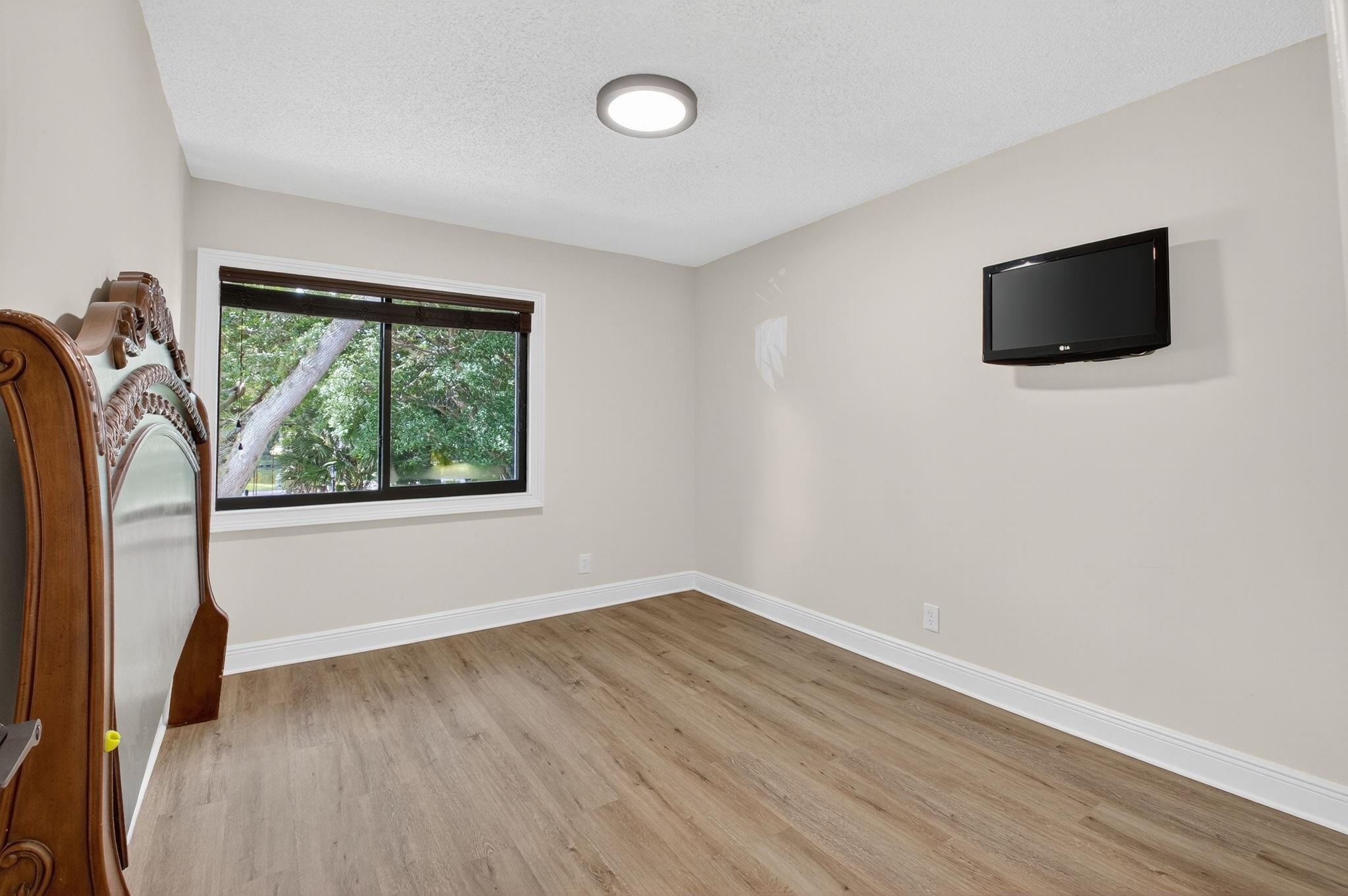 3802 Bridgewood Drive Boca Raton, FL 33434 - Photo 25 of 46 wooden floor in an empty room with a window