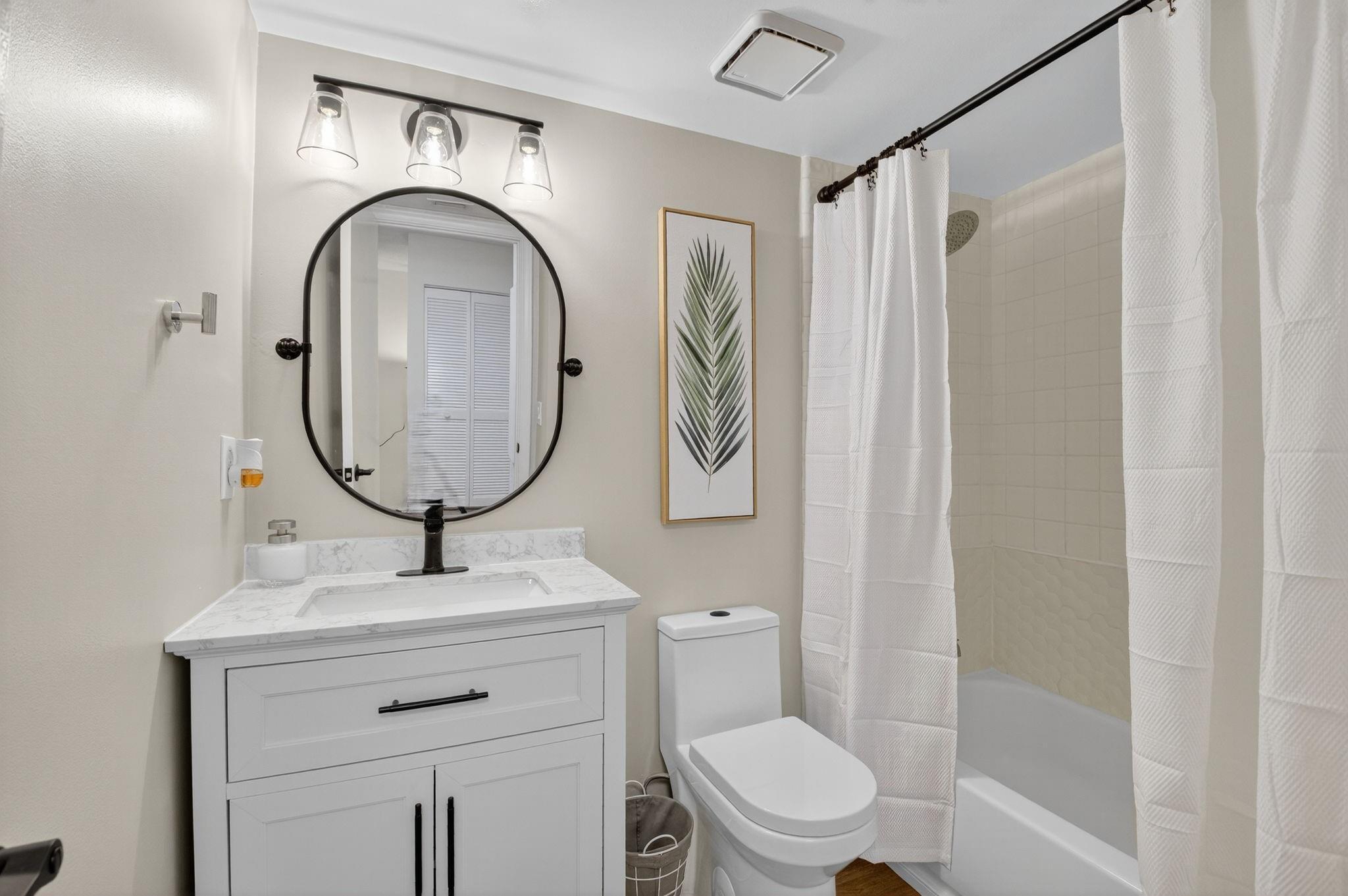 3802 Bridgewood Drive Boca Raton, FL 33434 - Photo 27 of 46 a bathroom with a toilet a sink and a mirror