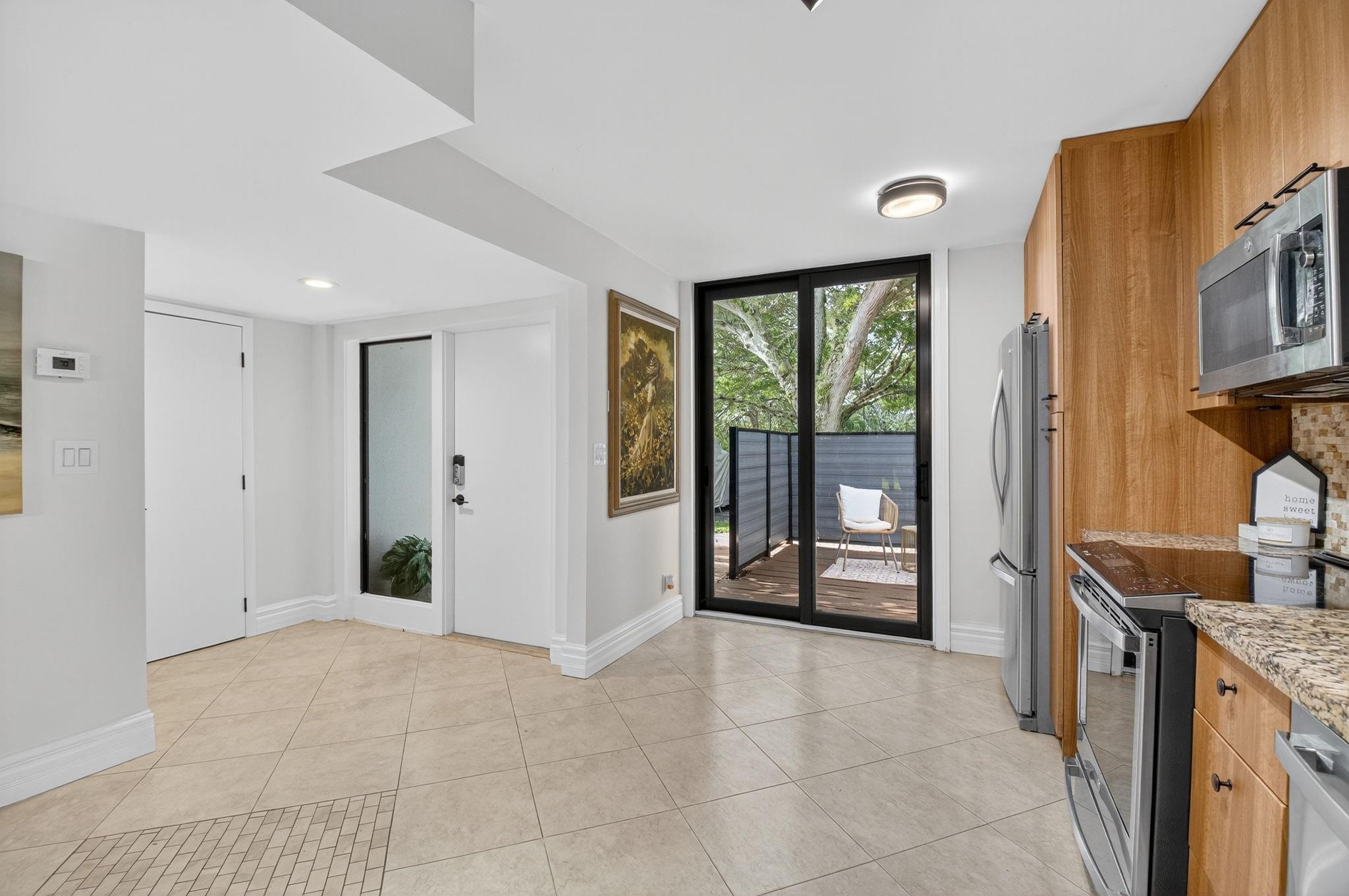 3802 Bridgewood Drive Boca Raton, FL 33434 - Photo 29 of 46 a living room with stainless steel appliances granite countertop furniture a large window and a rug