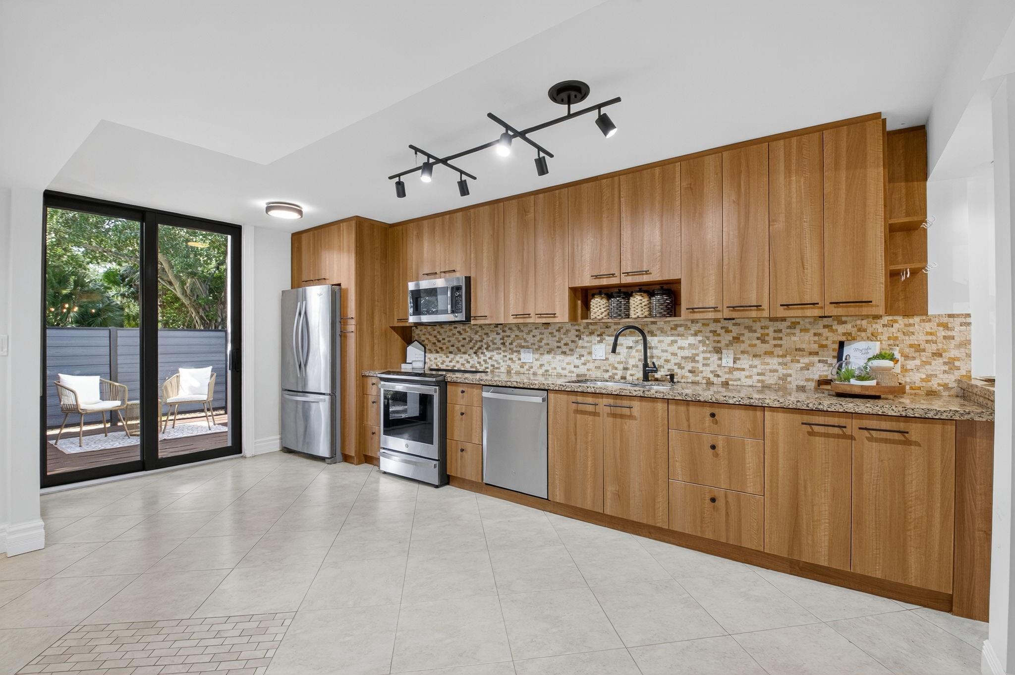 3802 Bridgewood Drive Boca Raton, FL 33434 - Photo 3 of 46 a kitchen with stainless steel appliances granite countertop a stove sink and cabinets