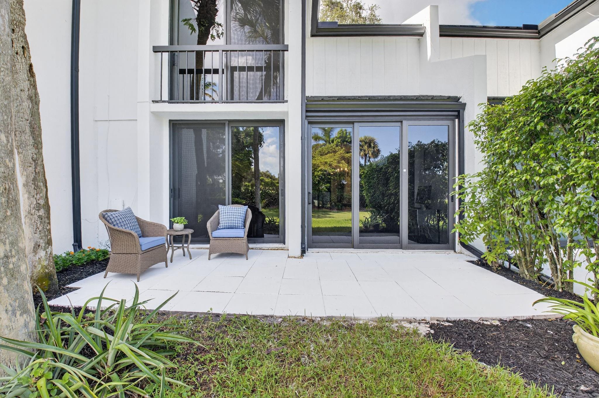 3802 Bridgewood Drive Boca Raton, FL 33434 - Photo 34 of 46 a view of a patio with table and chairs and potted plants