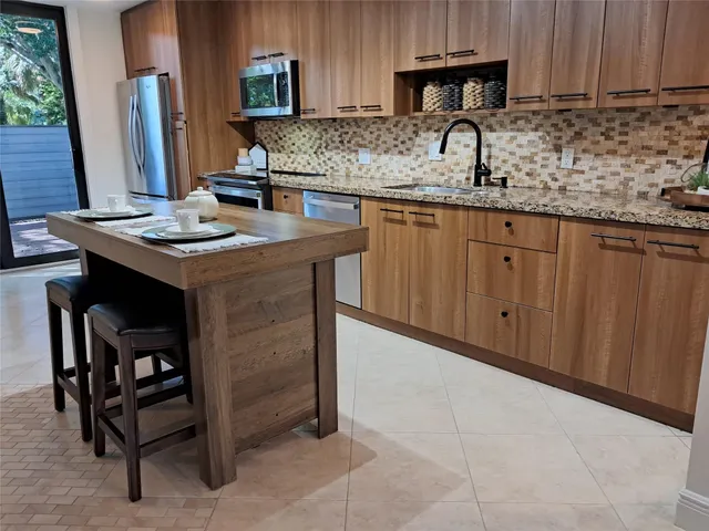 a kitchen with stainless steel appliances granite countertop a sink and cabinets