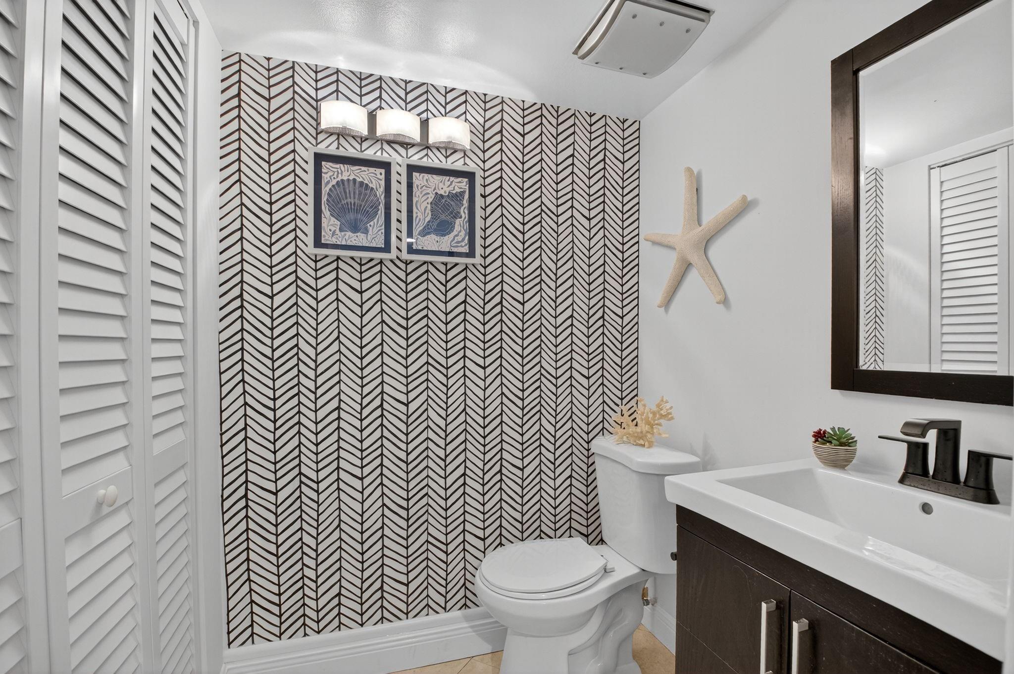 3802 Bridgewood Drive Boca Raton, FL 33434 - Photo 7 of 46 a bathroom with a sink a toilet and mirror