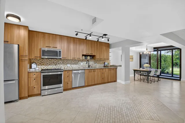 a kitchen with a stove a sink and a refrigerator