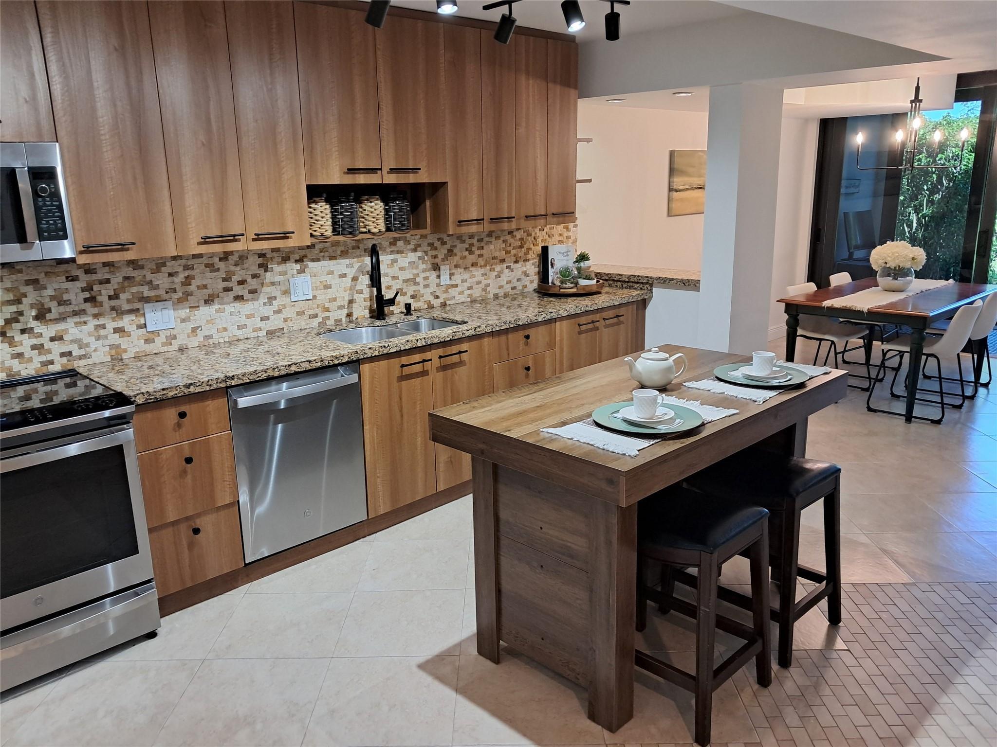 3802 Bridgewood Drive Boca Raton, FL 33434 - Photo 9 of 46 a kitchen with a sink cabinets and wooden floor