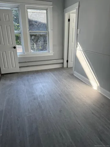 a white toilet sitting next to a bathtub