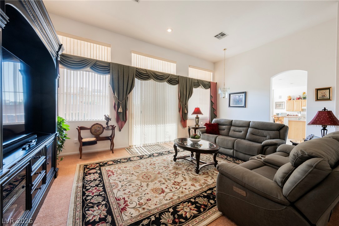 5494 Pine Ranch Street Las Vegas, NV 89113 - Photo 18 of 54 A generous living room with towering ceilings and broad windows offers plentiful light and comfort.