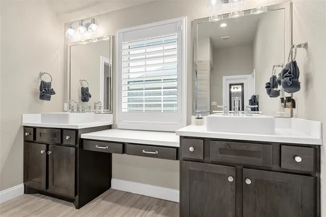 a bathroom with a sink double vanity and a mirror