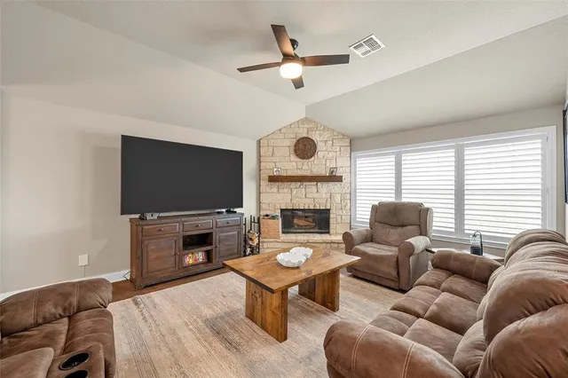 a living room with furniture fireplace and a flat screen tv