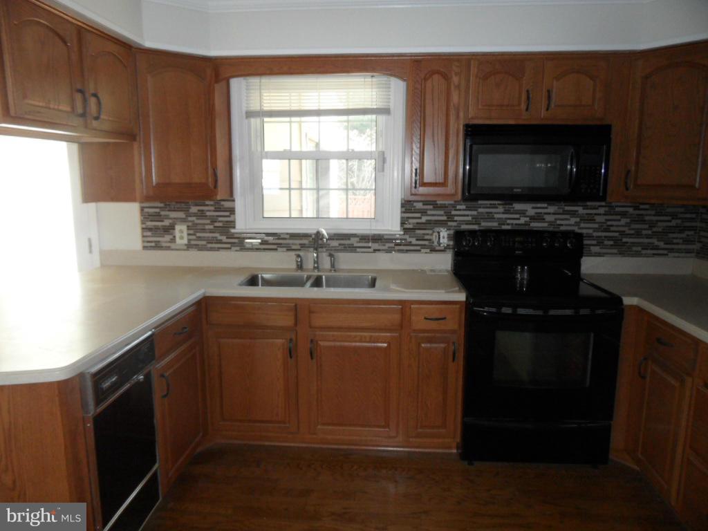 1405 Clearview Road Edgewood, MD 21040 - Photo 6 of 23 a kitchen with a sink stove and microwave