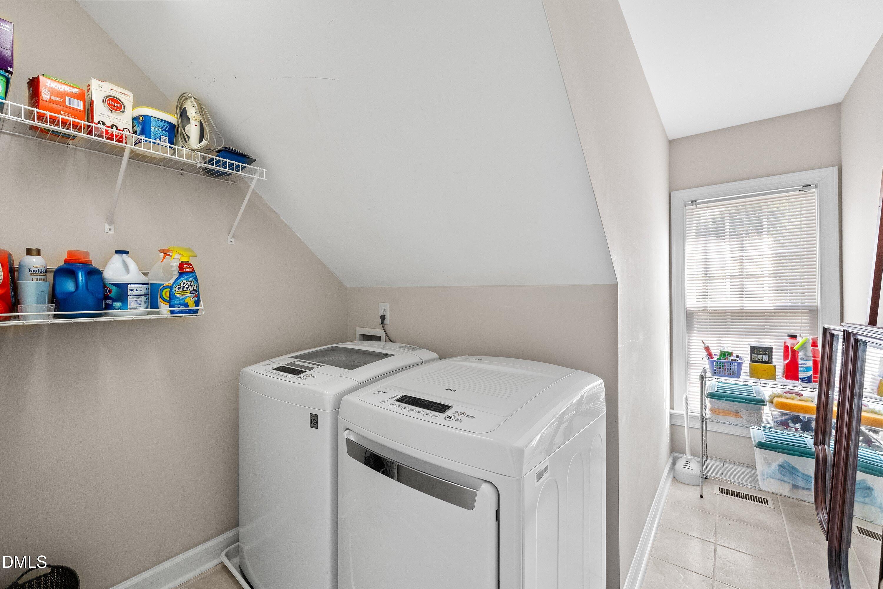 3914 Sterling Ridge Lane Durham, NC 27707 - Photo 46 of 66 Dedicated laundry area featuring a window, tiled flooring, and built-in shelving