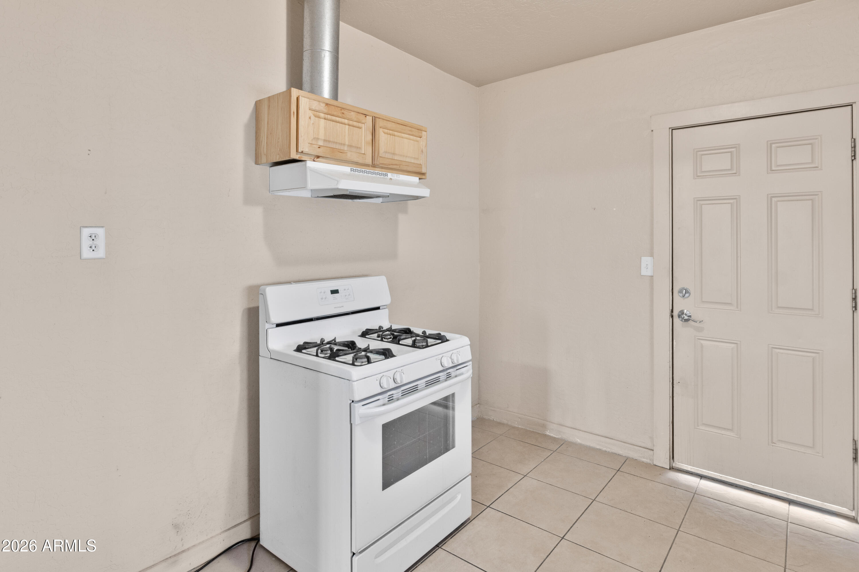 1237 East Pierce Street Phoenix, AZ 85006 - Photo 11 of 23 a kitchen with cabinets and white stove
