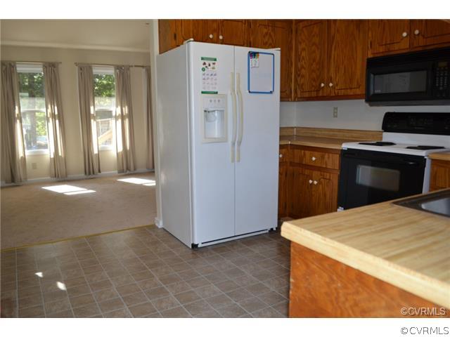 15804 Tri Gate Road Chester, VA 23831 - Photo 5 of 13 a kitchen with a refrigerator and a stove