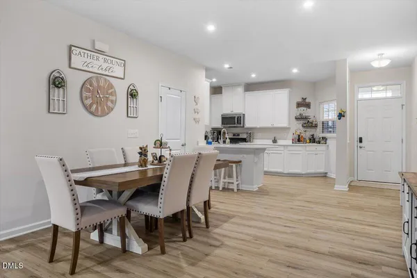 a view of a dining room with furniture and wooden floor