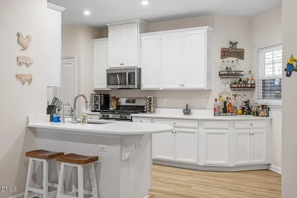 a kitchen with stainless steel appliances granite countertop a sink stove and cabinets