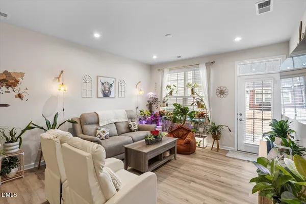 a living room with furniture and a potted plant