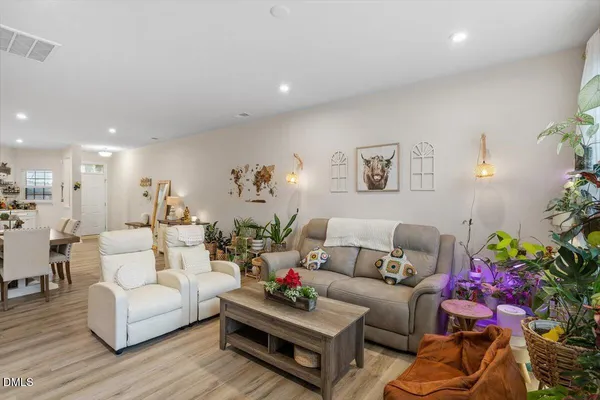 a living room with furniture and flowers