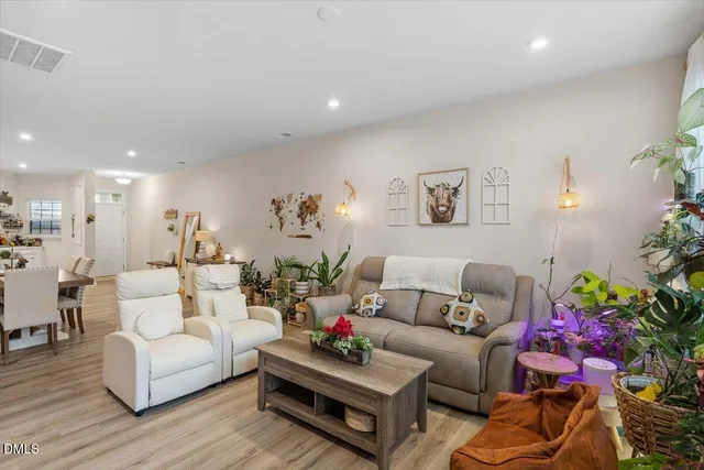 a living room with furniture and flowers