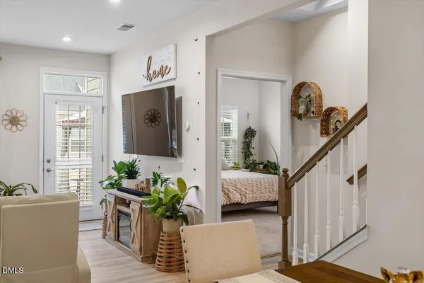 a living room with furniture and wooden floor