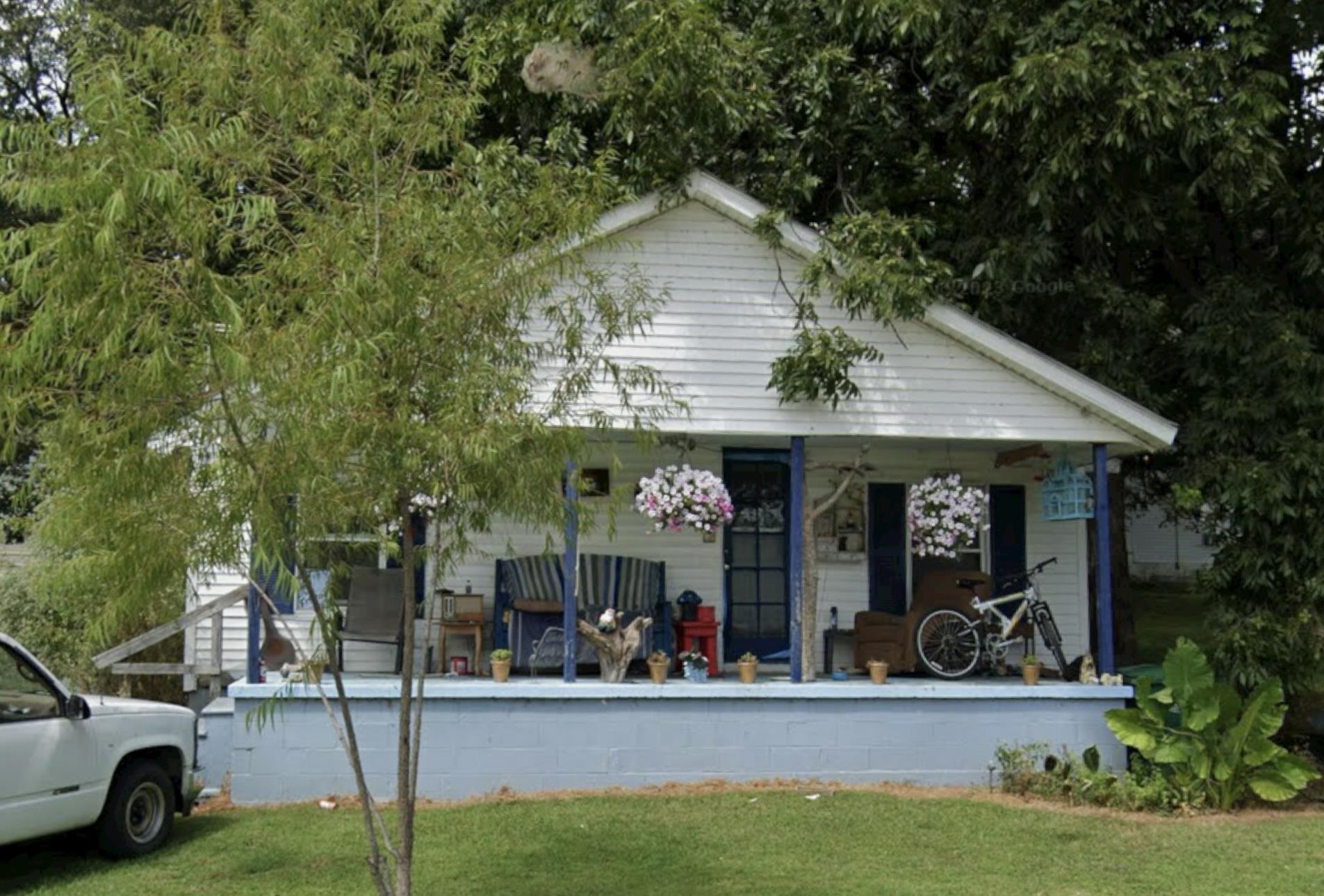 a view of a chairs and table in front of retail shop