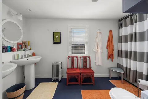 a living room with furniture a rug and a window