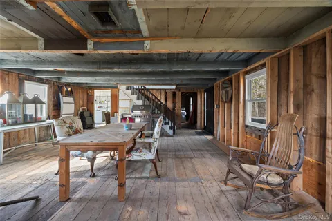 a view of a room with furniture and wooden floor