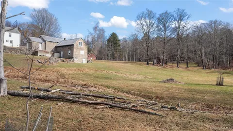 a swimming pool view with a seating space and a swimming pool