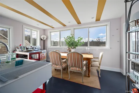 a dining room with furniture and wooden floor