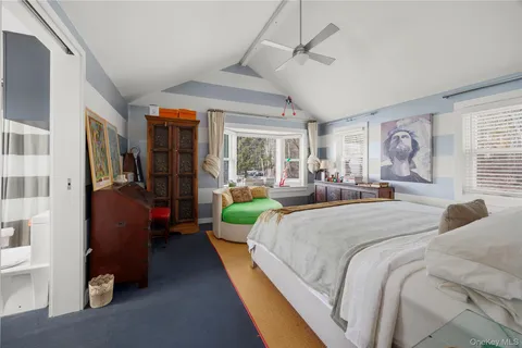 a bedroom with a bed and a large window