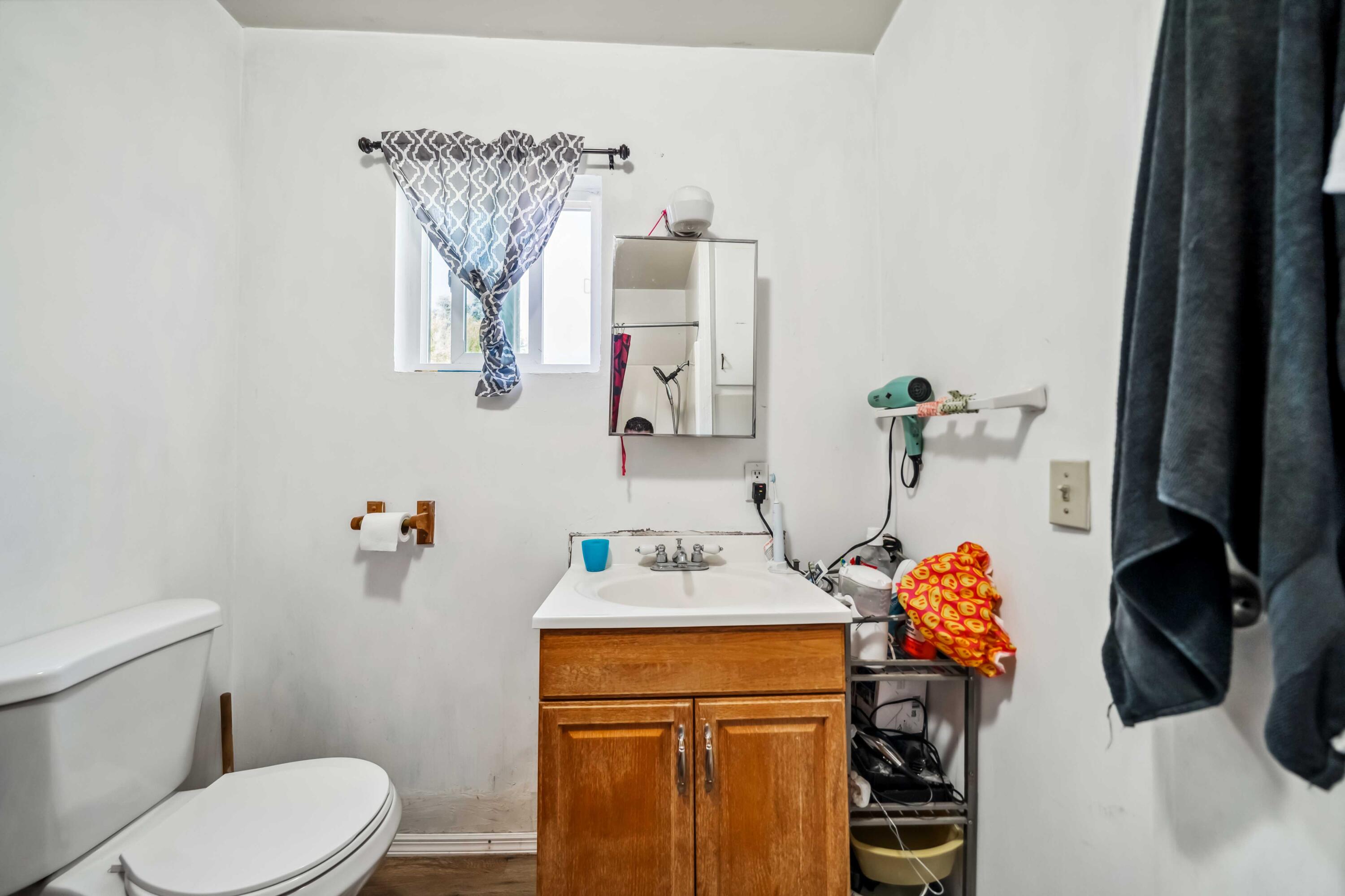 5450 Cedars Road Redding, CA 96001 - Photo 13 of 21 a bathroom with a sink toilet and mirror