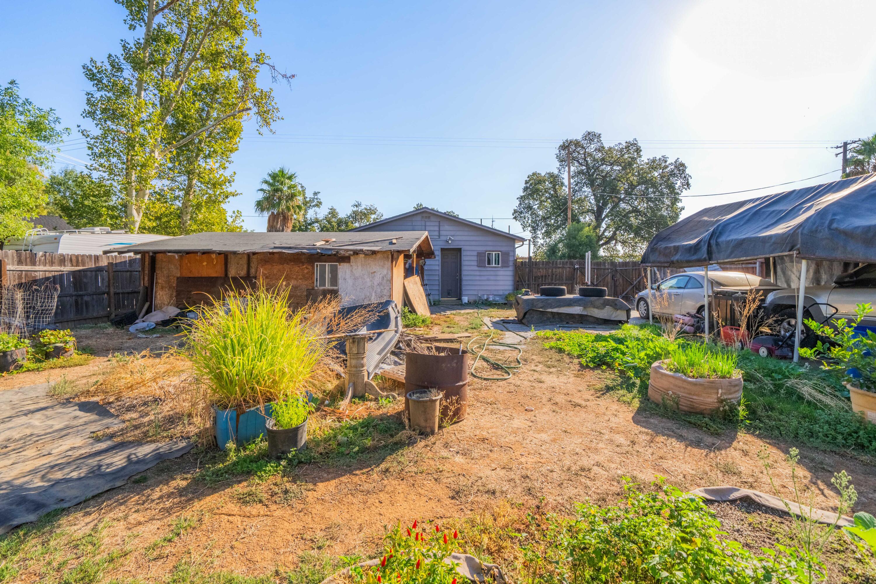5450 Cedars Road Redding, CA 96001 - Photo 16 of 21 a view of a backyard with plants and a patio