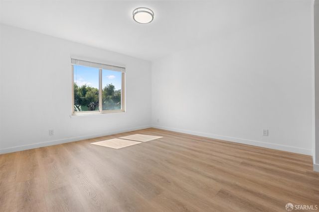 an empty room with wooden floor