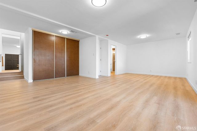 a bathroom with a granite countertop sink a toilet and a mirror