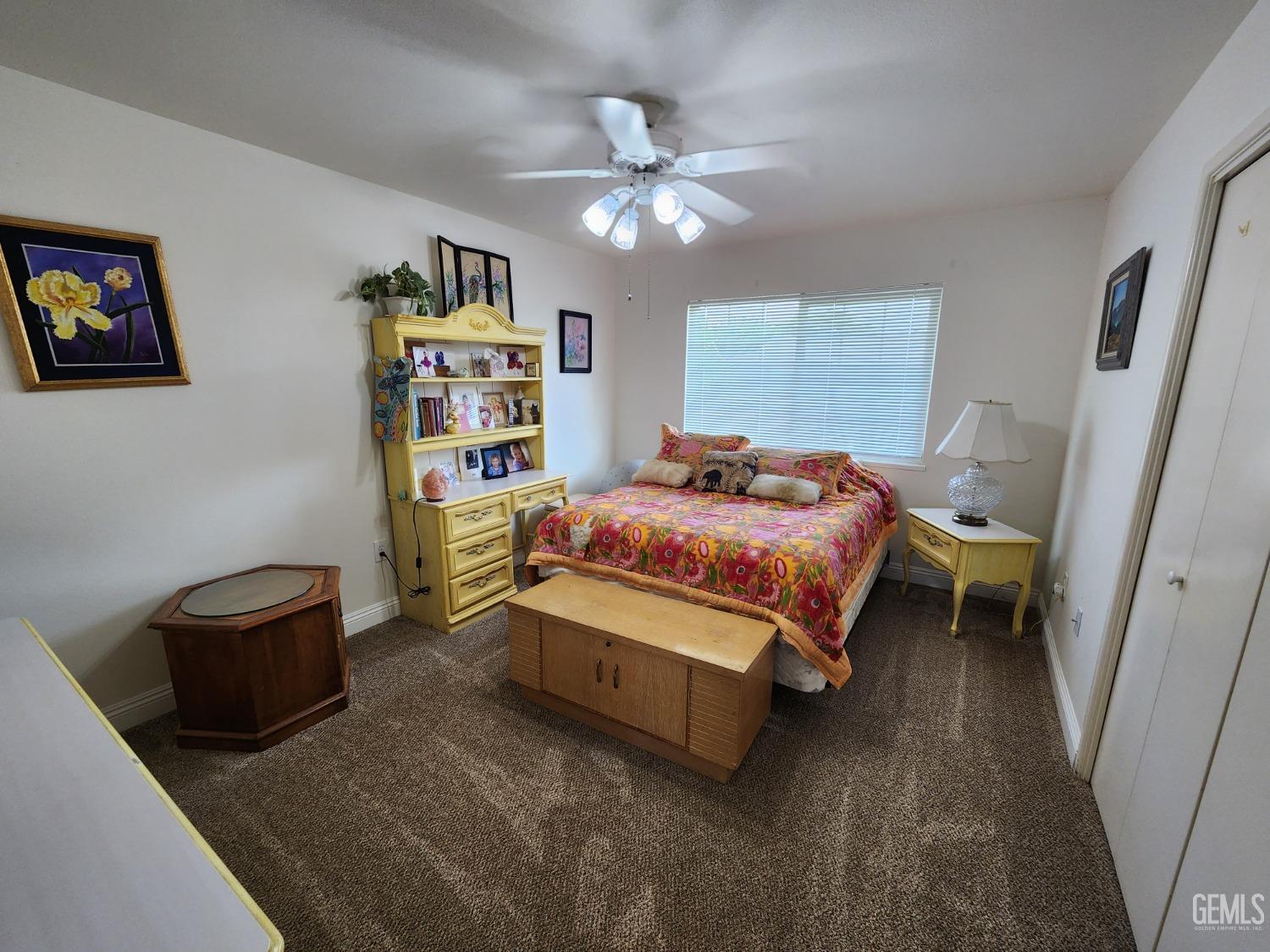 Undisclosed Address Bakersfield, CA 93309 - Photo 11 of 22 a bedroom with a bed and a chandelier