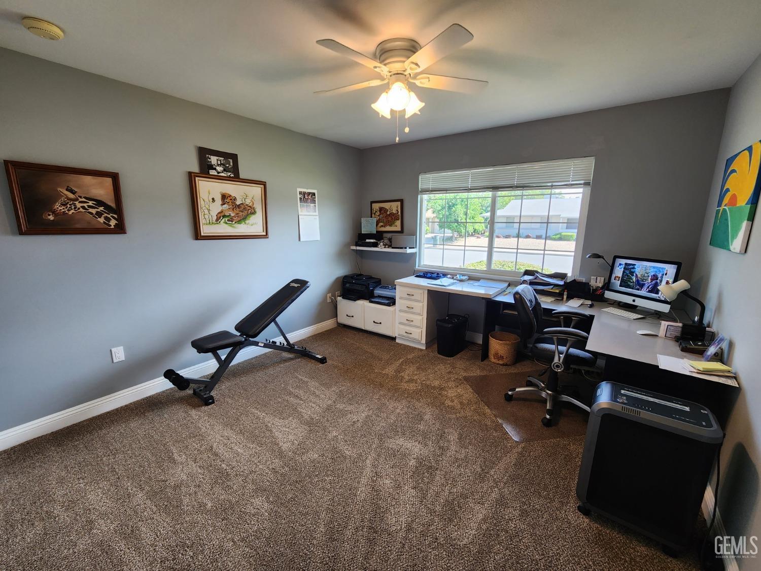Undisclosed Address Bakersfield, CA 93309 - Photo 12 of 22 a view of a workspace with furniture and a window