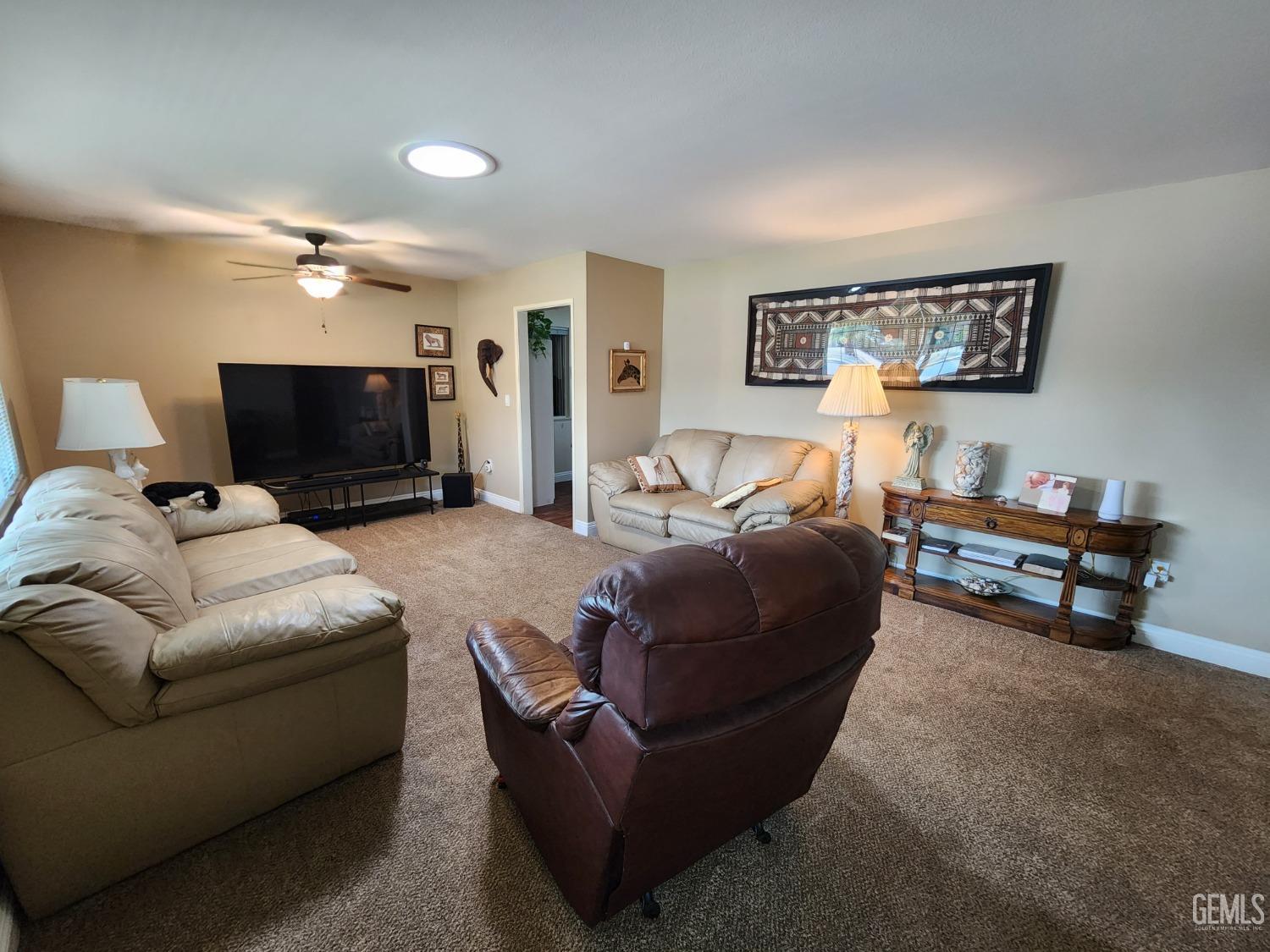 Undisclosed Address Bakersfield, CA 93309 - Photo 3 of 22 a living room with furniture and a flat screen tv