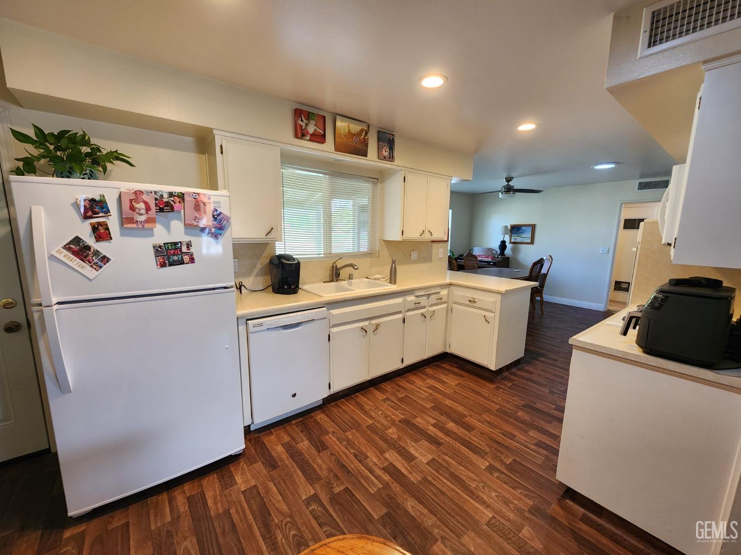 Undisclosed Address Bakersfield, CA 93309 - Photo 5 of 22 a white refrigerator freezer sitting inside of a kitchen