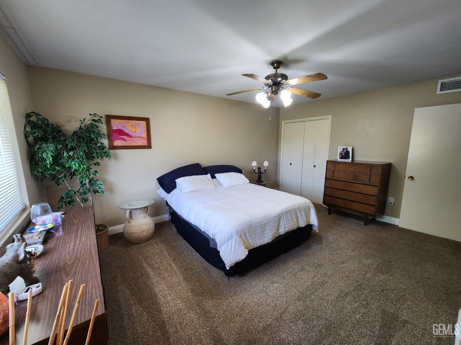 Undisclosed Address Bakersfield, CA 93309 - Photo 9 of 22 a bedroom with a bed and a chandelier