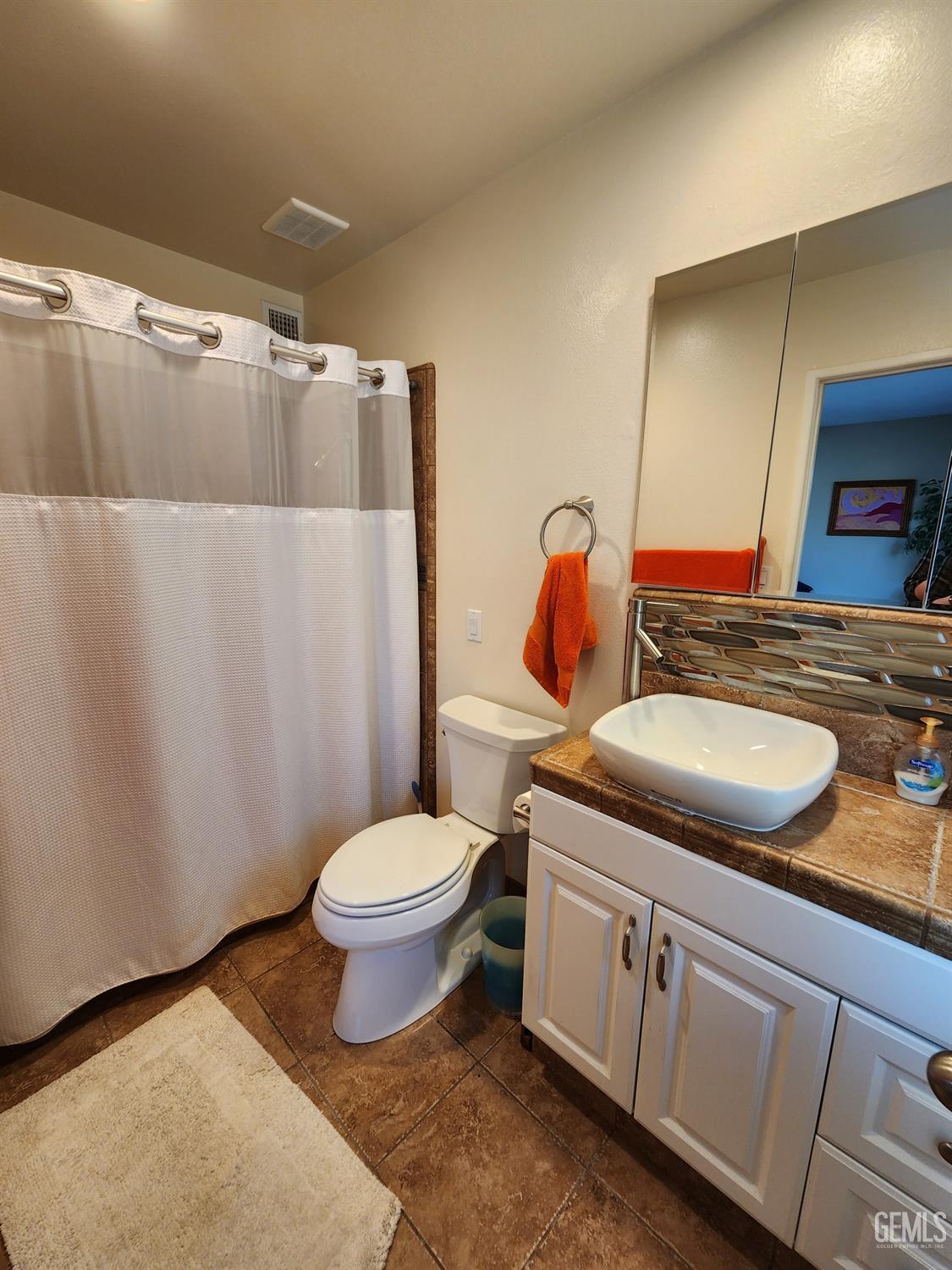 Undisclosed Address Bakersfield, CA 93309 - Photo 10 of 22 a bathroom with a granite countertop toilet sink and mirror
