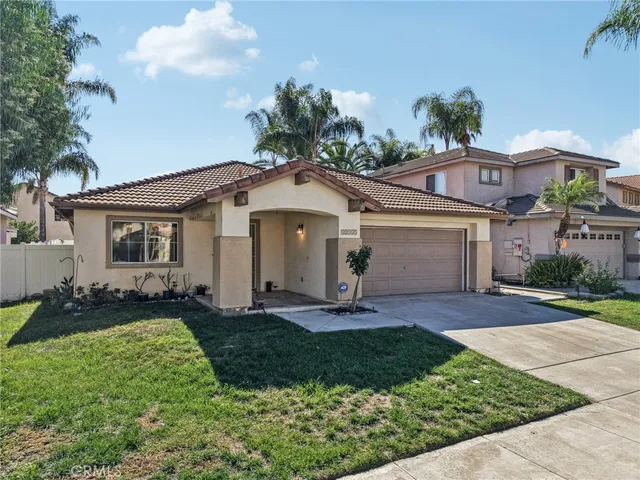 a front view of a house with a yard and outdoor seating