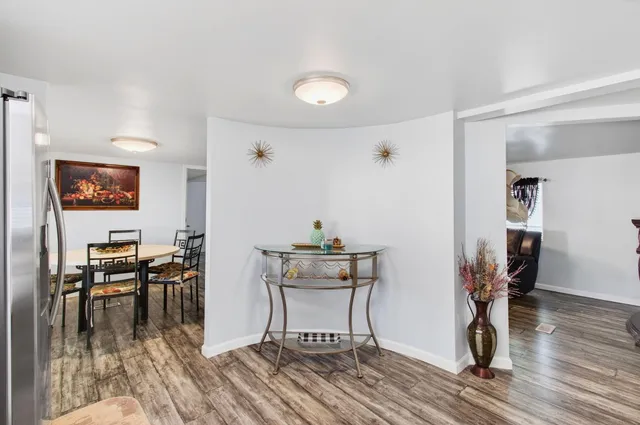 a view of a dining room with furniture and wooden floor