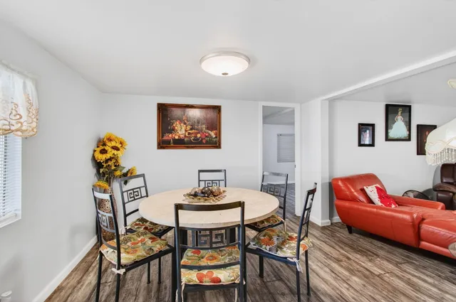 a view of a hallway with furniture and wooden floor